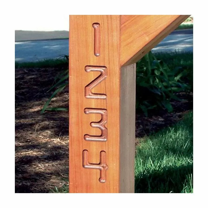 Close-up of wooden post with routed carved numbers 1 2 3 4 outdoors, woodworking detail