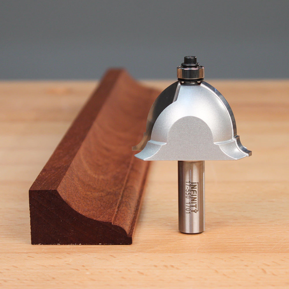 Cove and bead router bit next to decorative wooden moulding on workbench