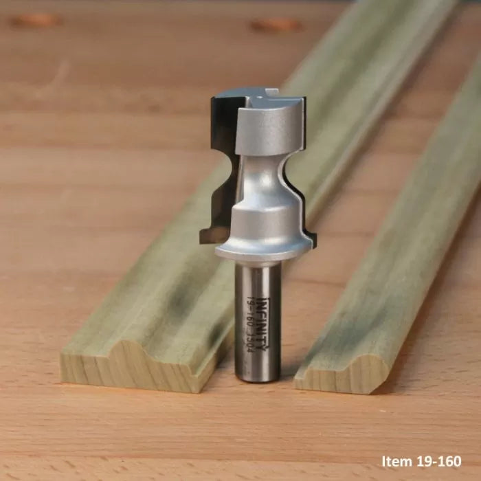 Woodworking router bit with decorative moulding profile on wooden board