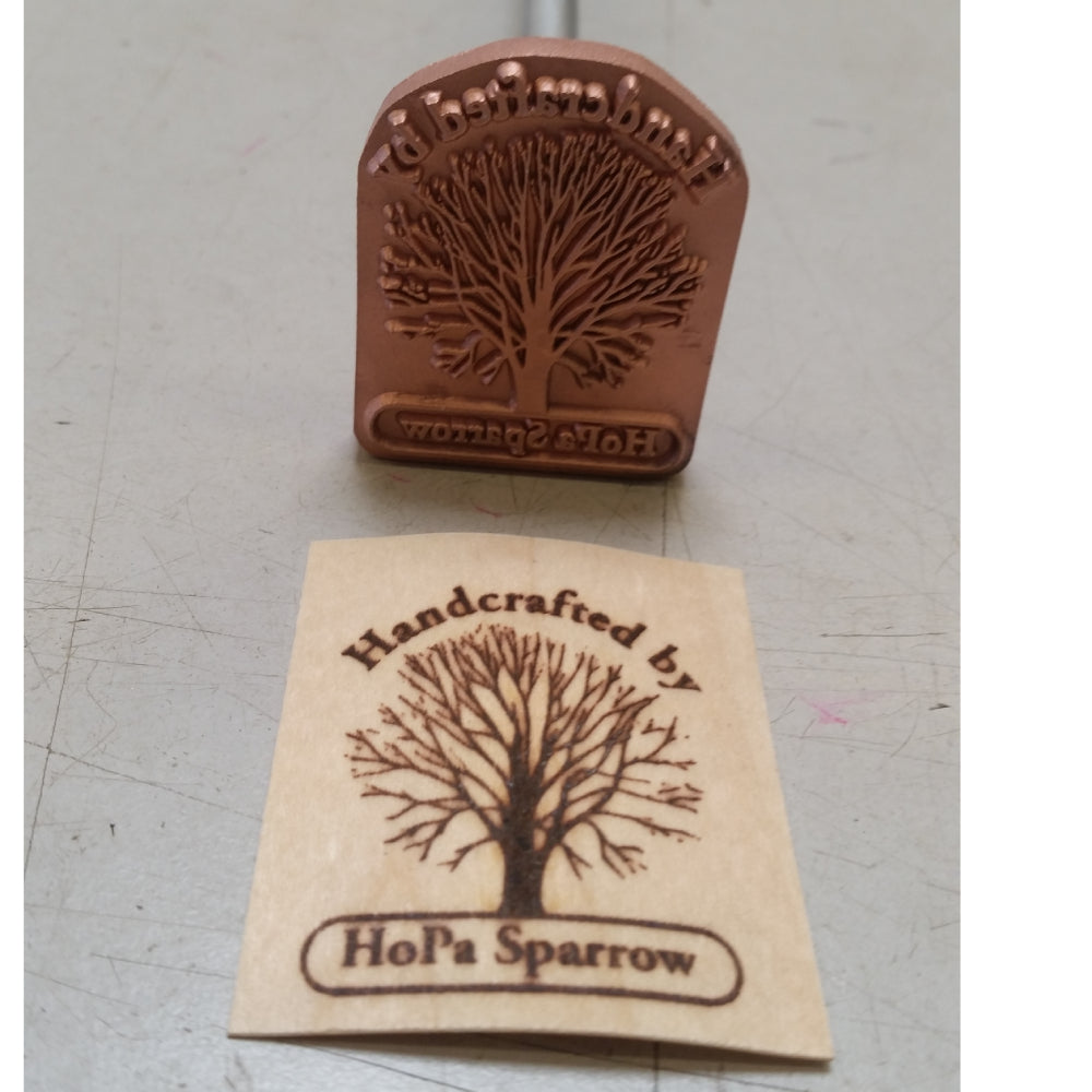 Custom metal wood branding iron with tree design and stamped wood label