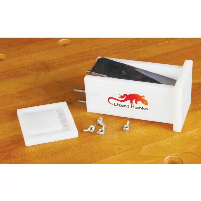 Acrylic pen blank mold with screws and lid on a wooden workbench, ideal for woodworking projects.