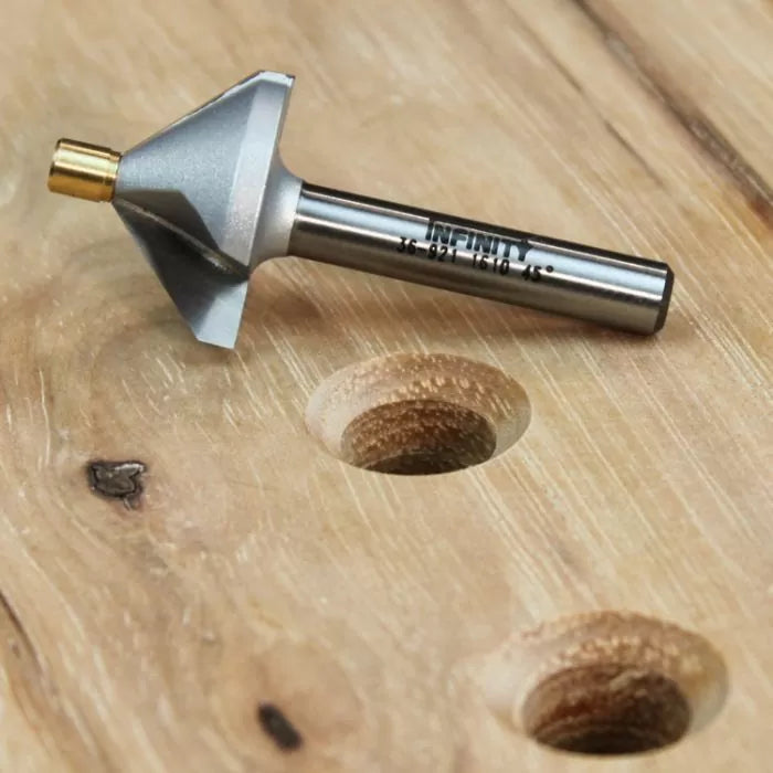 Chamfer router bit for woodworking on wood surface with clean chamfered holes