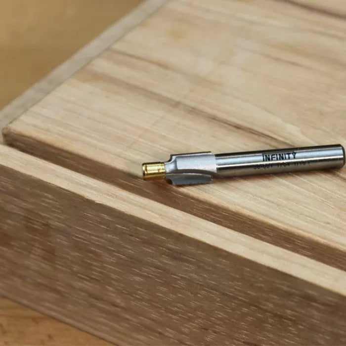 Carbide woodworking router bit on a wooden surface for precision joinery cuts