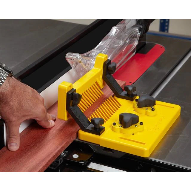 Featherboard safety device holding wood against a table saw fence during precise woodworking