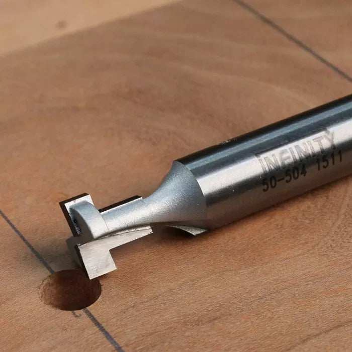 Dovetail router bit cutting a groove in a wooden board for woodworking projects.