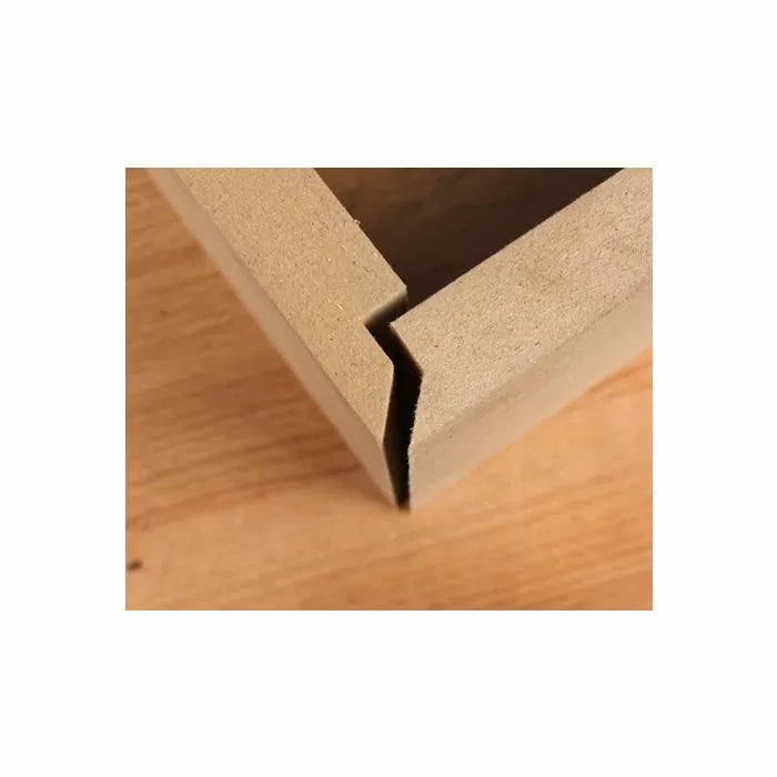 Close-up of a wooden mitered corner joint with an angled interlocking cut on a workbench.