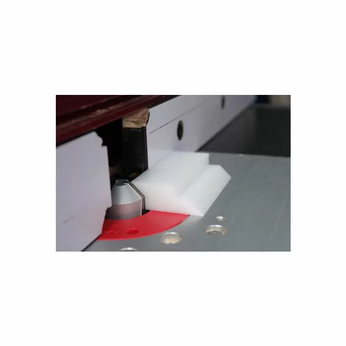Router table setup with router bit and white push block for woodworking precision