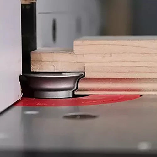 Roundover router bit cutting decorative edge on a piece of wood at a router table