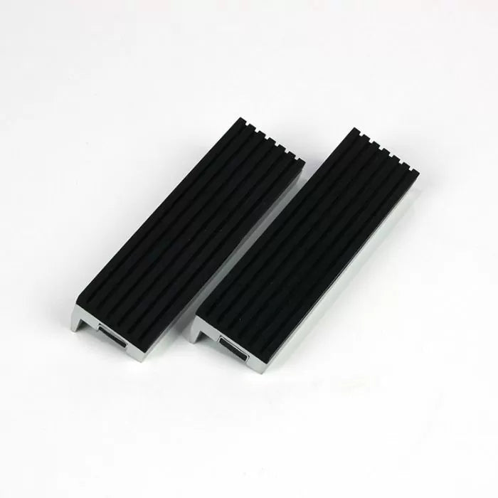 Pair of black aluminum woodworking vise jaw pads with textured grip on white background