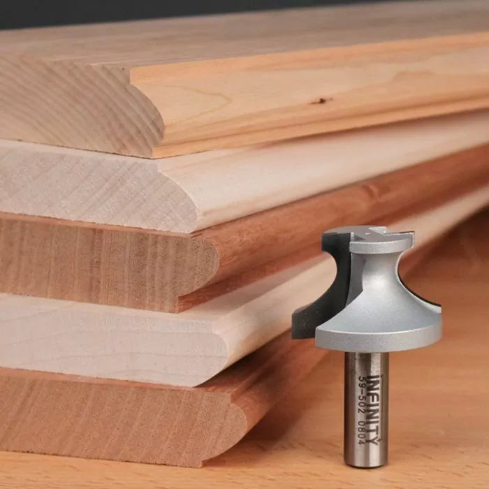 Roundover router bit with stacked wooden molding samples on a workbench for woodworking projects