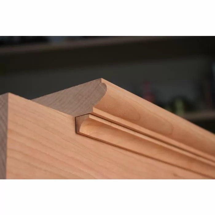 Close-up of decorative wood moulding profile on cabinet door, woodworking detail