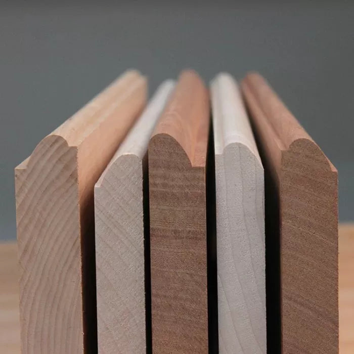 Close-up of five wood molding profiles with rounded edges for woodworking projects