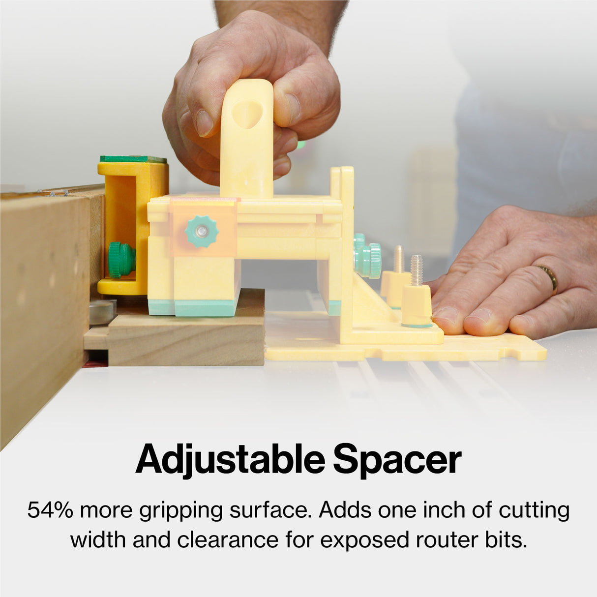 Person using an adjustable spacer woodworking tool on a router table for precise cutting.