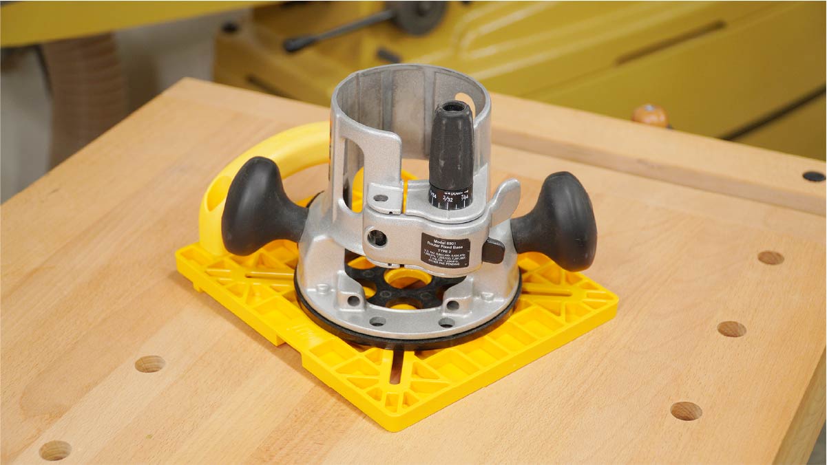 Woodworking router on yellow guide on workbench, precision cutting tool setup