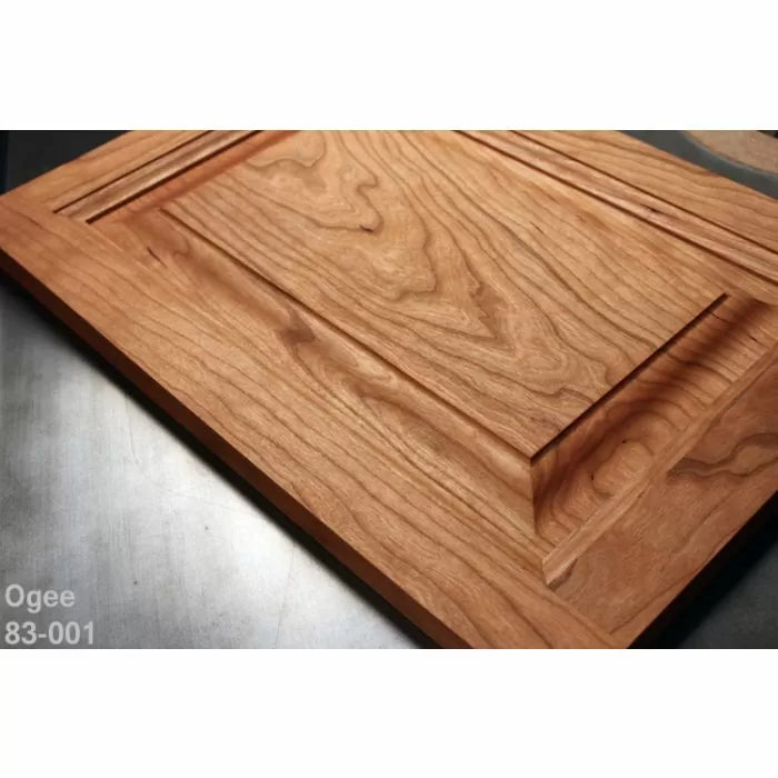 Close-up of cherry wood cabinet door with ogee profile, showcasing detailed woodworking.