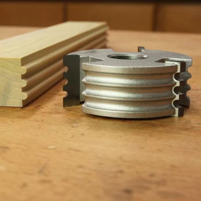 Display cutter head for woodworking with matching grooved wood profile on a workbench