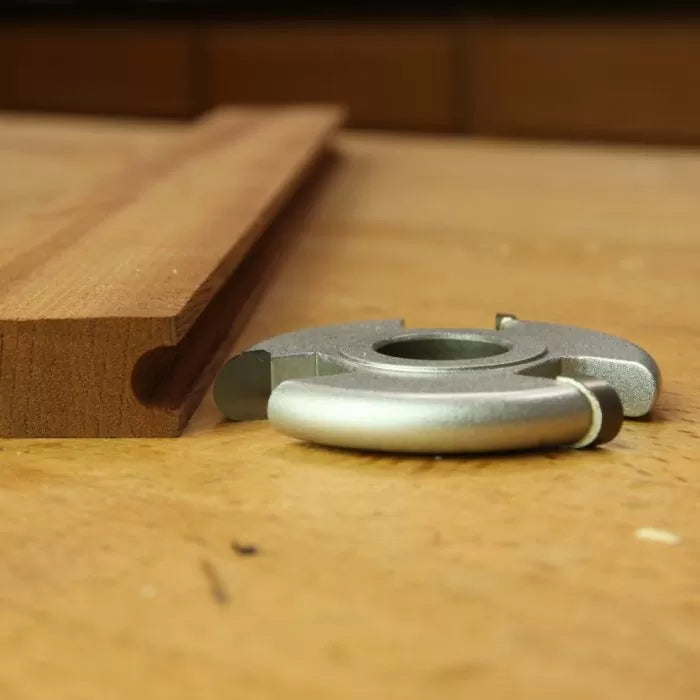 Woodworking edge cutter and profiled wood board on workbench