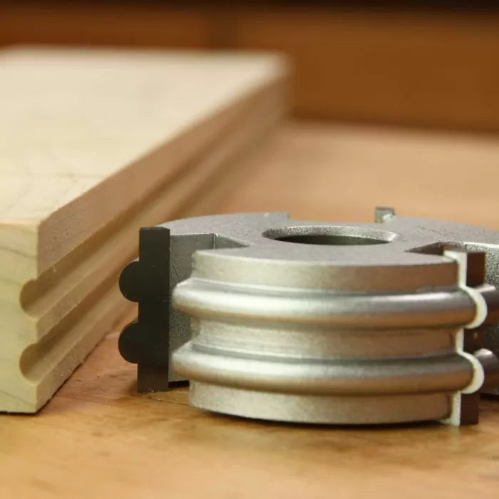 Display cutter woodworking tool with finished profile next to grooved wood board
