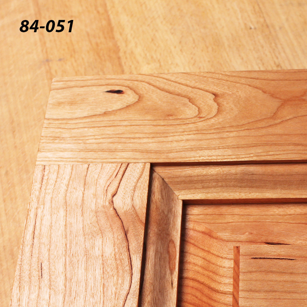 Close-up of unfinished wooden cabinet door corner showing precise joinery detail