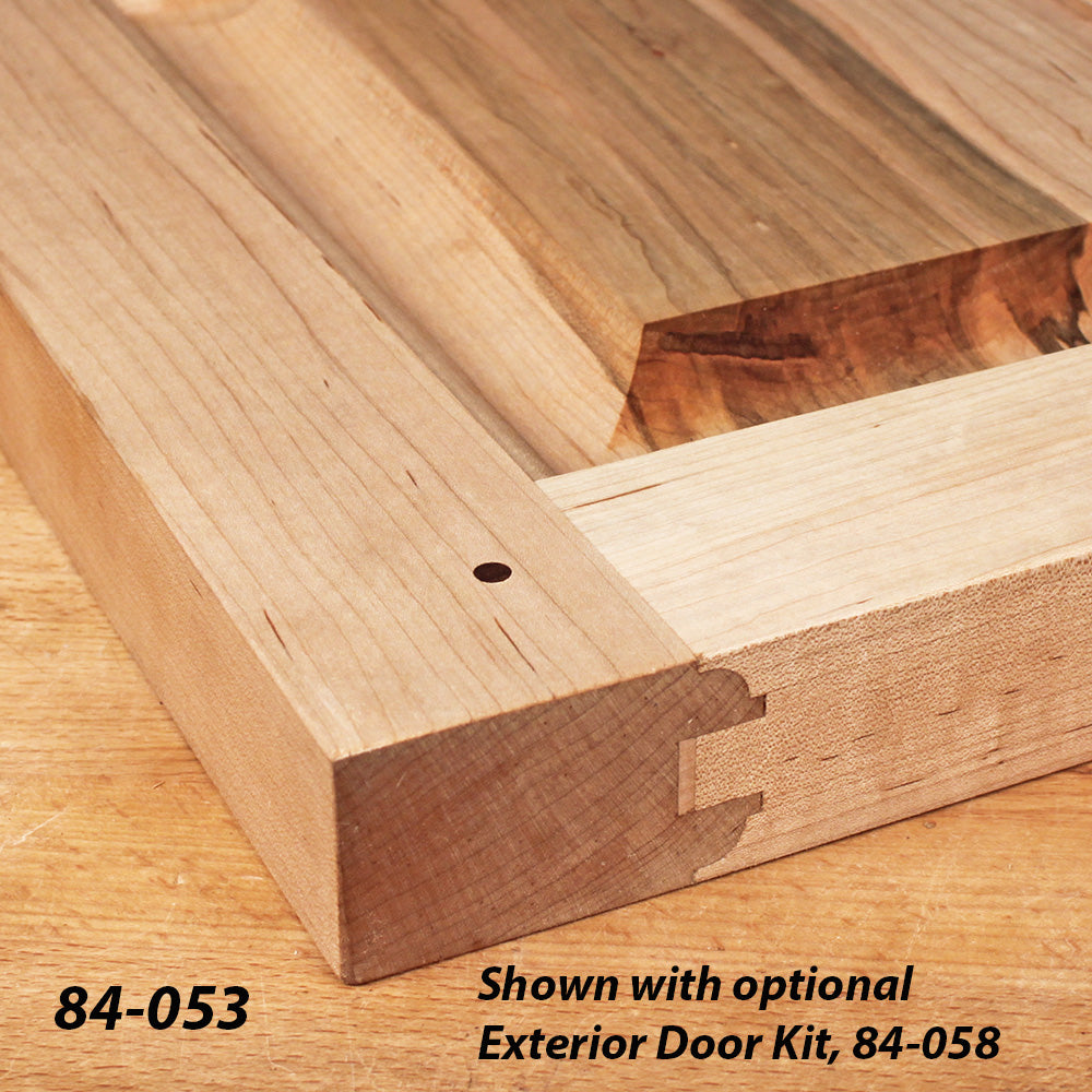 Closeup of wooden door frame joint detail on a woodworking project, showing precision joinery.