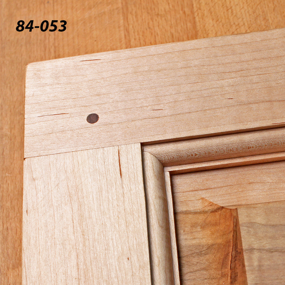 Close-up of a hardwood cabinet door joint with dowel, showing smooth joinery detail.