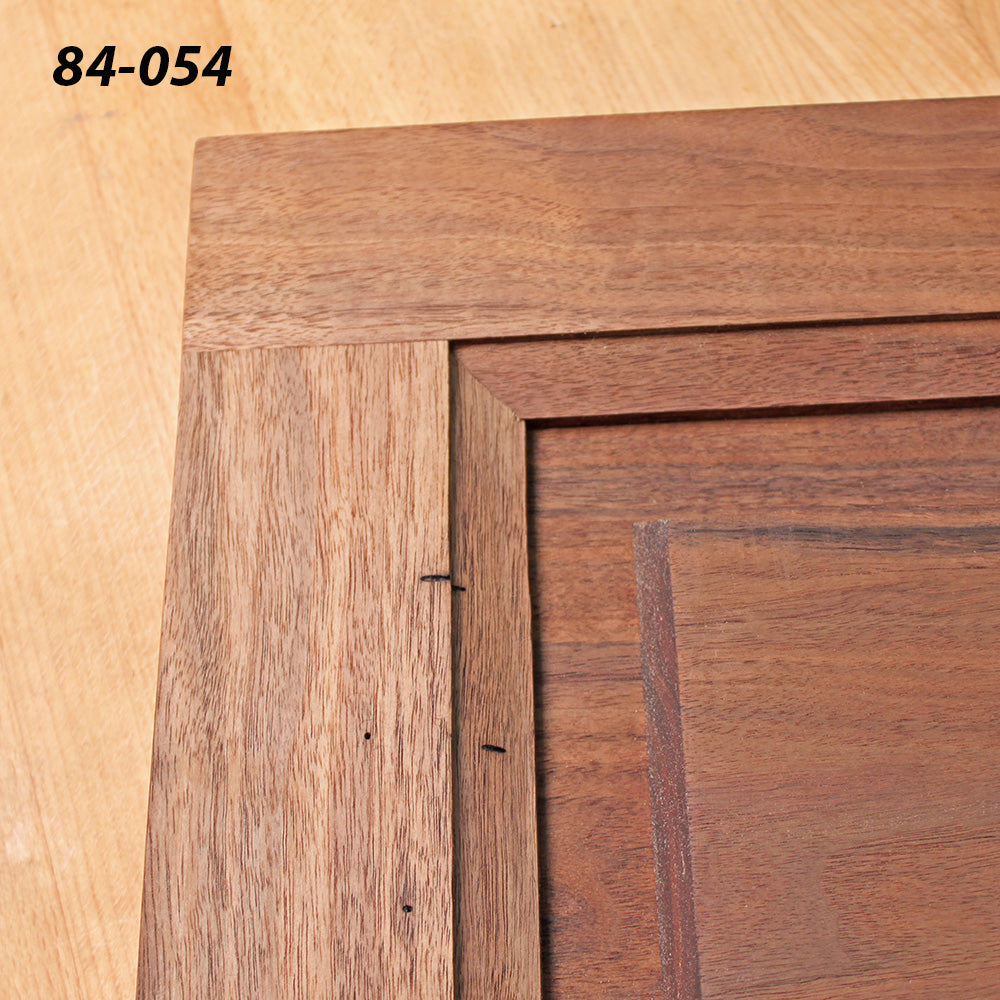 Close-up of a wooden cabinet door corner joint with visible dowels and smooth wood grain