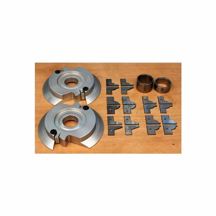 Woodworking shaper cutter set with interchangeable blades and bushings on a wooden surface