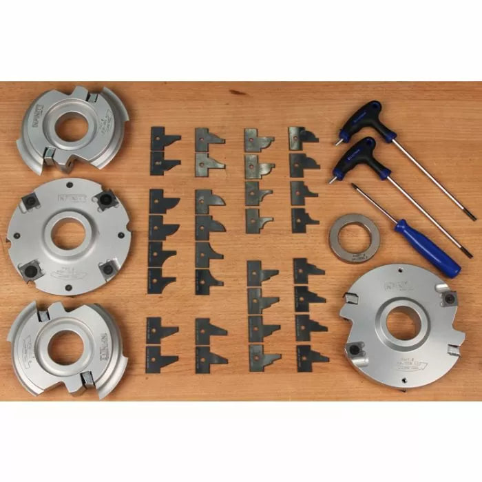 Woodworking cutterhead set with insert knives and hex wrenches on a wooden surface