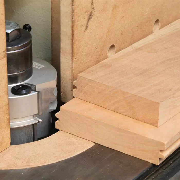 Wood router table set up with stacked panels and joinery router bit for woodworking