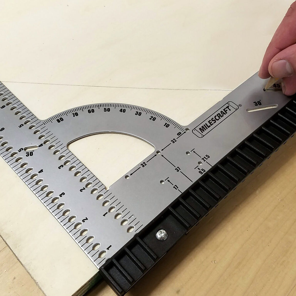Using the Milescraft FrameSquare protractor to lay out an angle on a plywood panel
