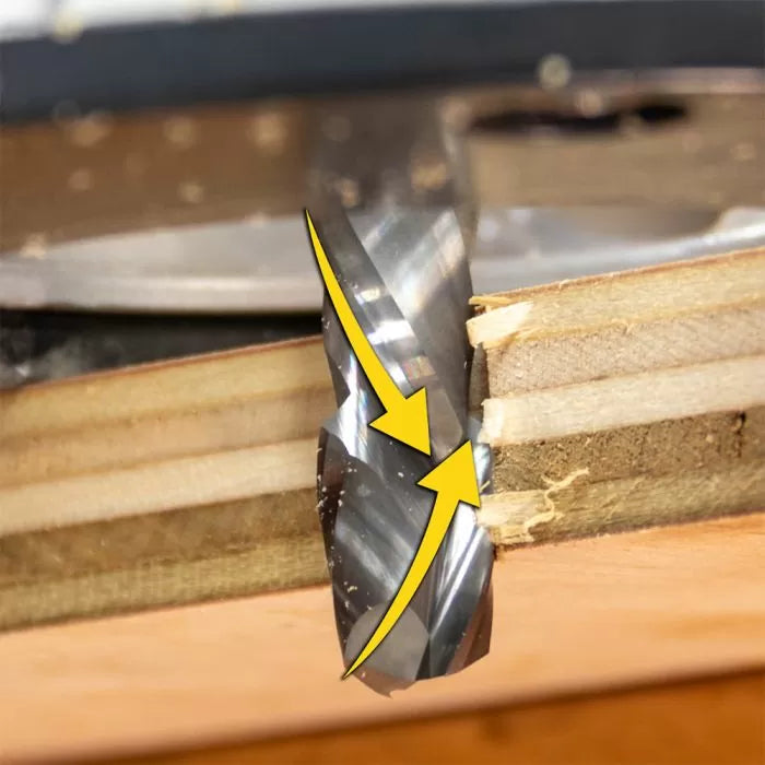 Close-up of spiral router bit cutting layered wood with highlighted cutting edges