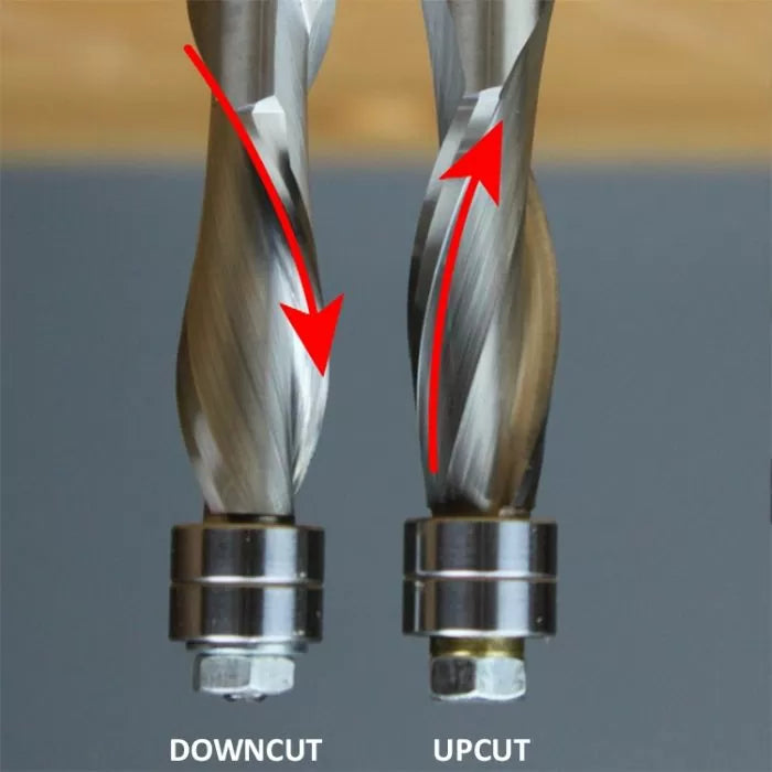 Close-up of downcut and upcut spiral router bits for woodworking, showing cutting direction.
