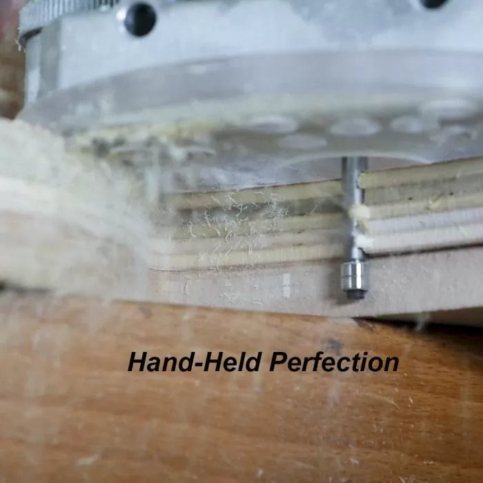 Handheld router cutting wood edge with straight router bit, producing fine wood shavings