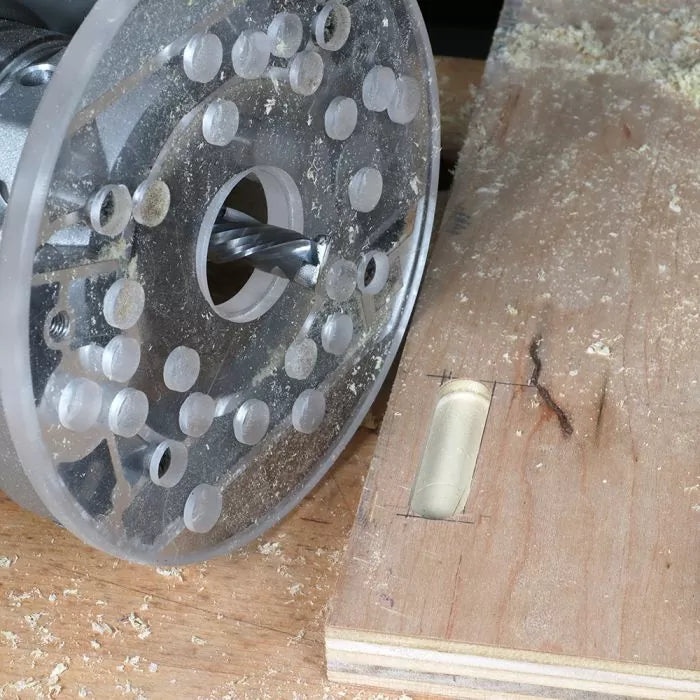 Wood router cutting mortise slot in plywood board with clear router baseplate