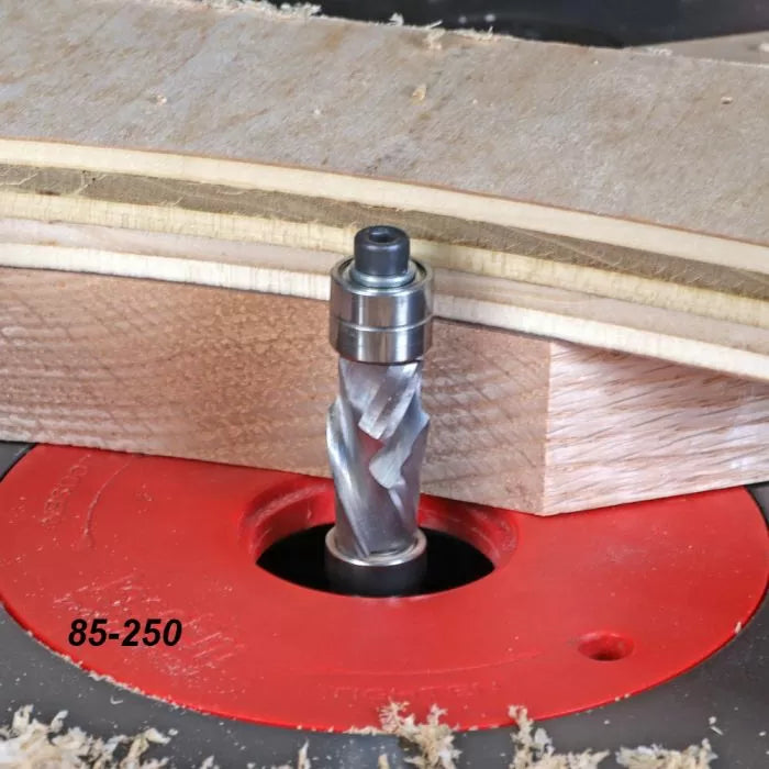 Spiral flush trim router bit in use on router table with wood template for woodworking