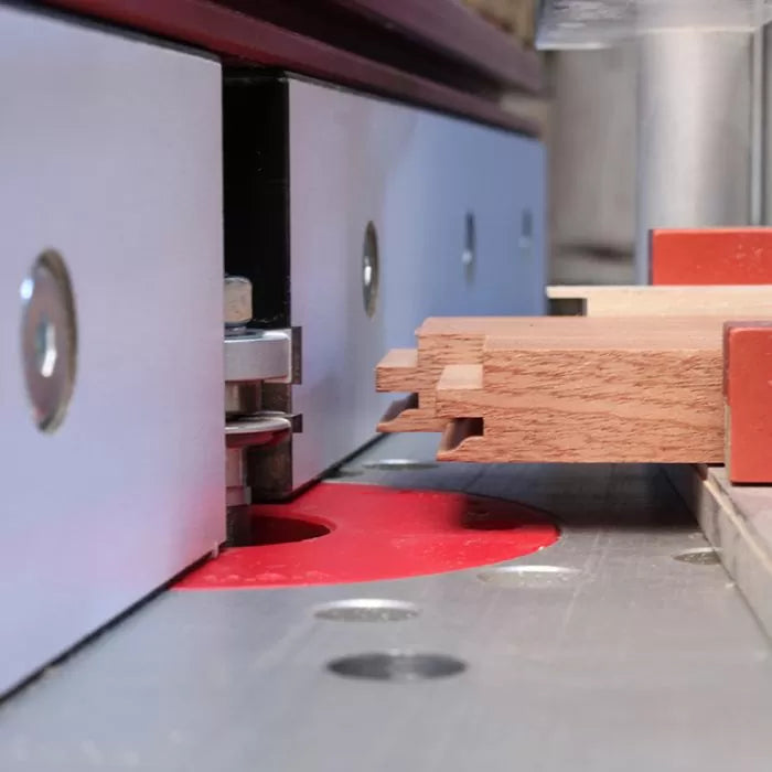 Wood board with box joint on router table using router bit for woodworking precision