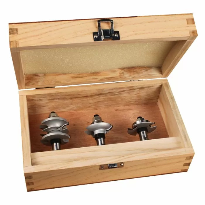 Woodworking router bit set in open wooden case, three steel bits for precision cutting