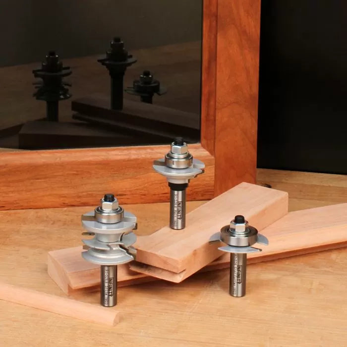 Table edge router bits for woodworking, displayed with wood boards and mirror reflection