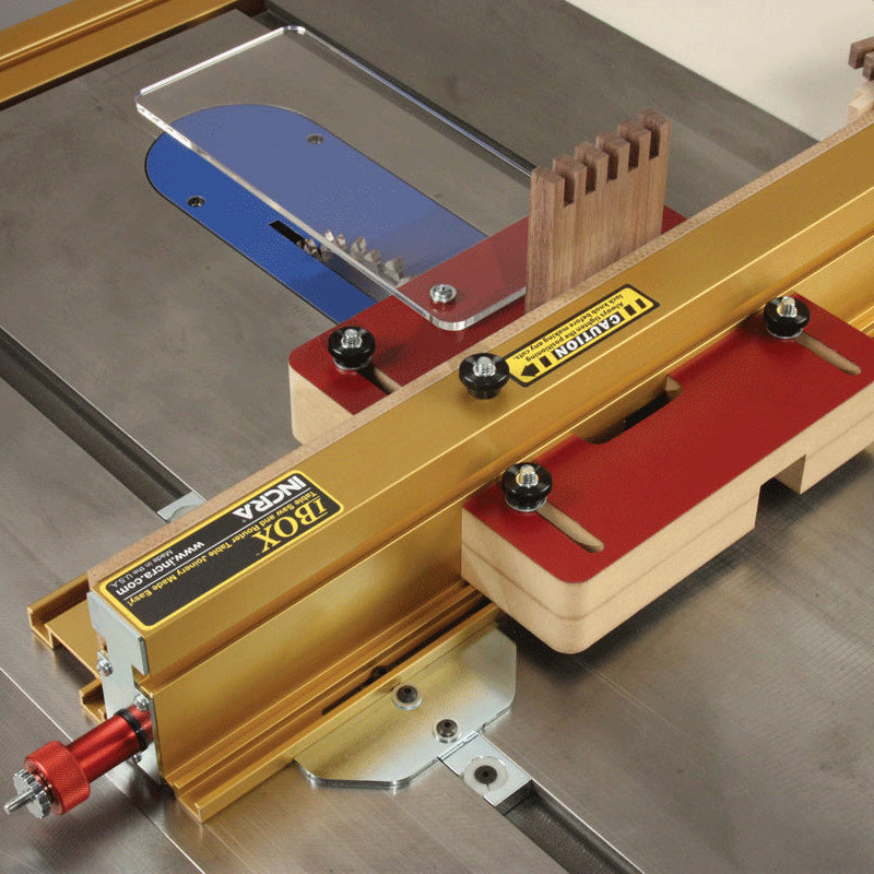 Table saw box joint jig setup with gold fence and precision woodworking accessory in use
