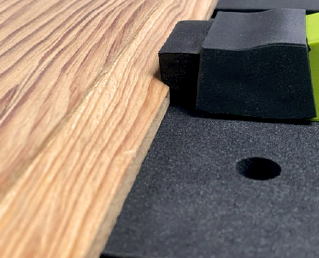 Bow clamp securing wood on a workbench for woodworking precision