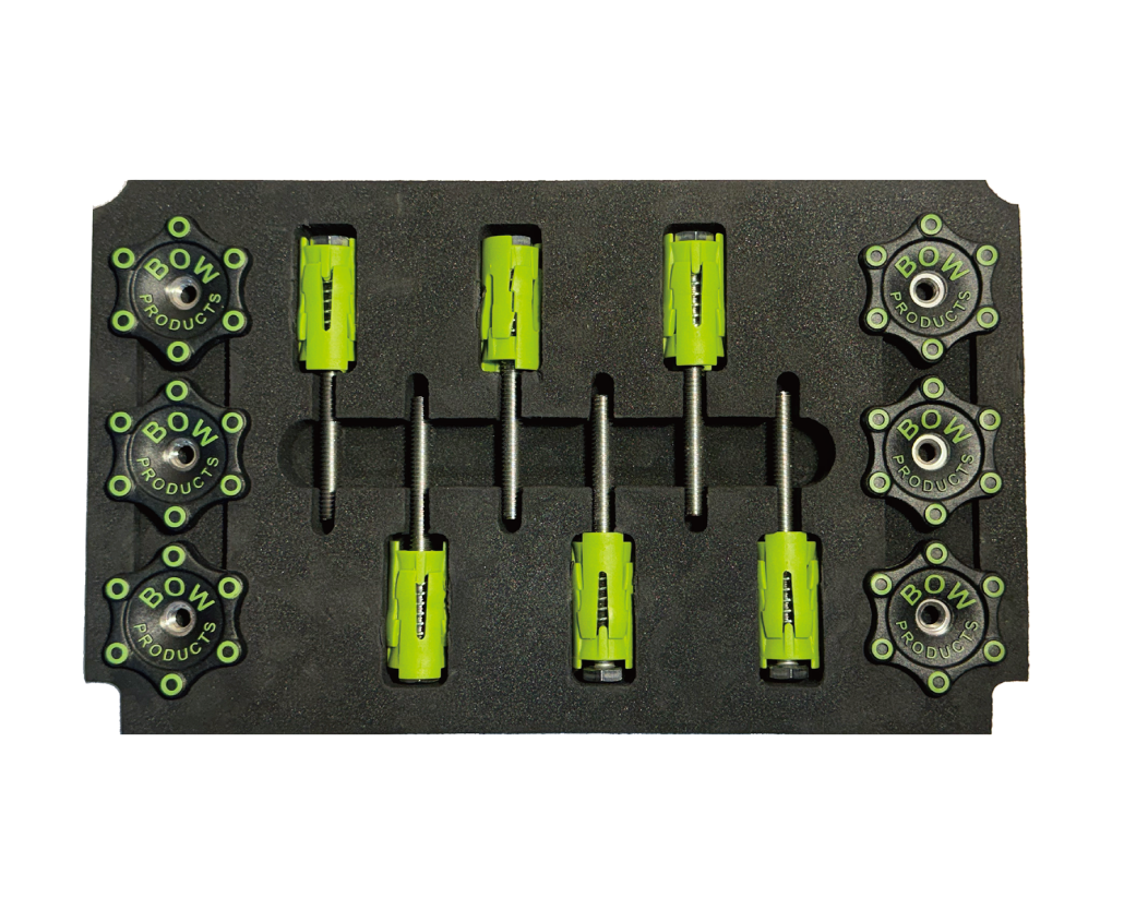 Pack of green woodworking hold-down clamps and knobs in foam tray