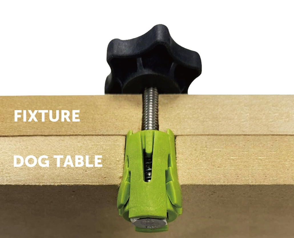 Workbench dog table clamp with black knob and green fixture securing wooden surface