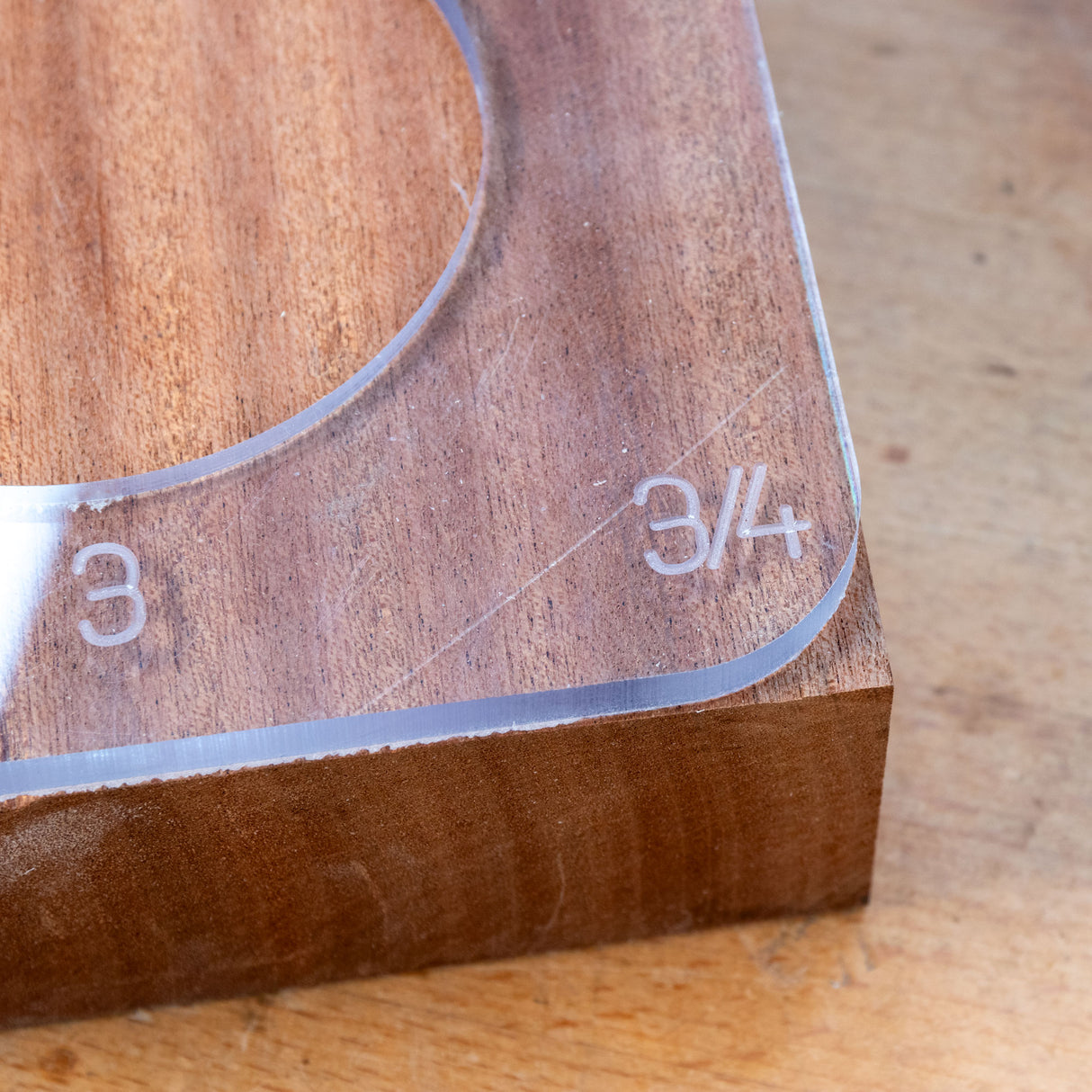Acrylic circle and radius cutting template on wood, labeled with 3 and 3/4 inch measurements.