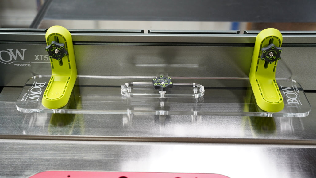 Table saw jig with clear acrylic base and green adjustable supports on metal saw fence