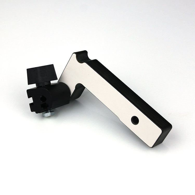 Router table flip stop accessory with aluminum and black plastic parts on white background