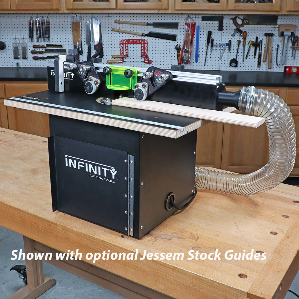 Router table with JessEm stock guides, dust collection hose, and woodworking tools in workshop