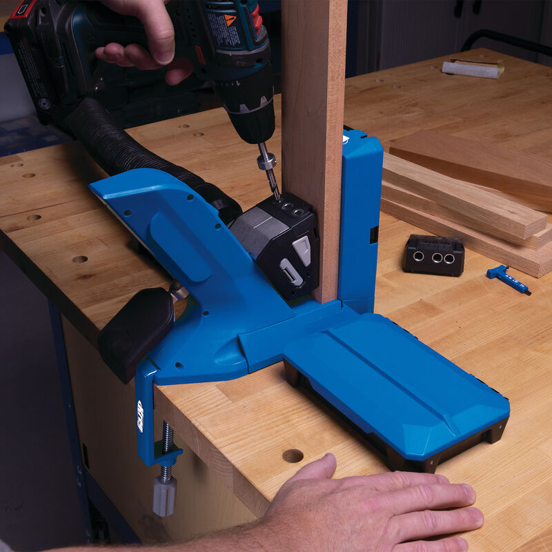 Pocket hole jig system clamped to workbench with power drill for woodworking joinery