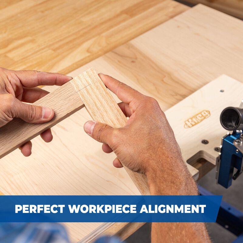 Hands aligning two wooden boards on a woodworking bench with joinery tool visible.