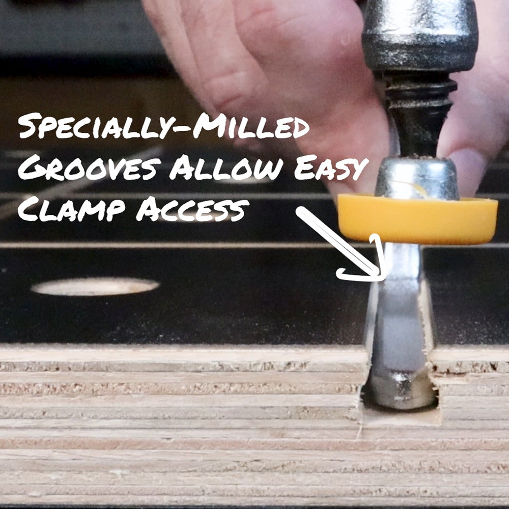 Workbench top with specially-milled grooves for easy clamp access, hand using clamp