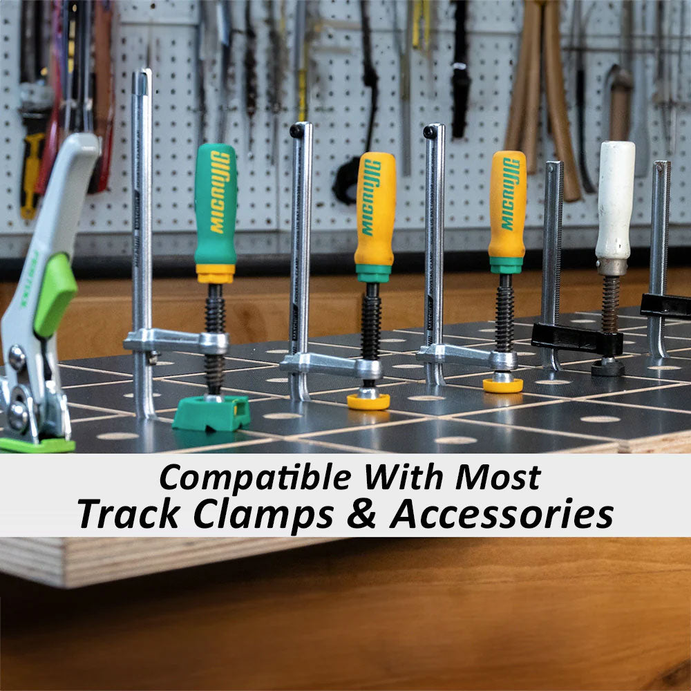 Workbench top with multiple track clamps and woodworking accessories installed